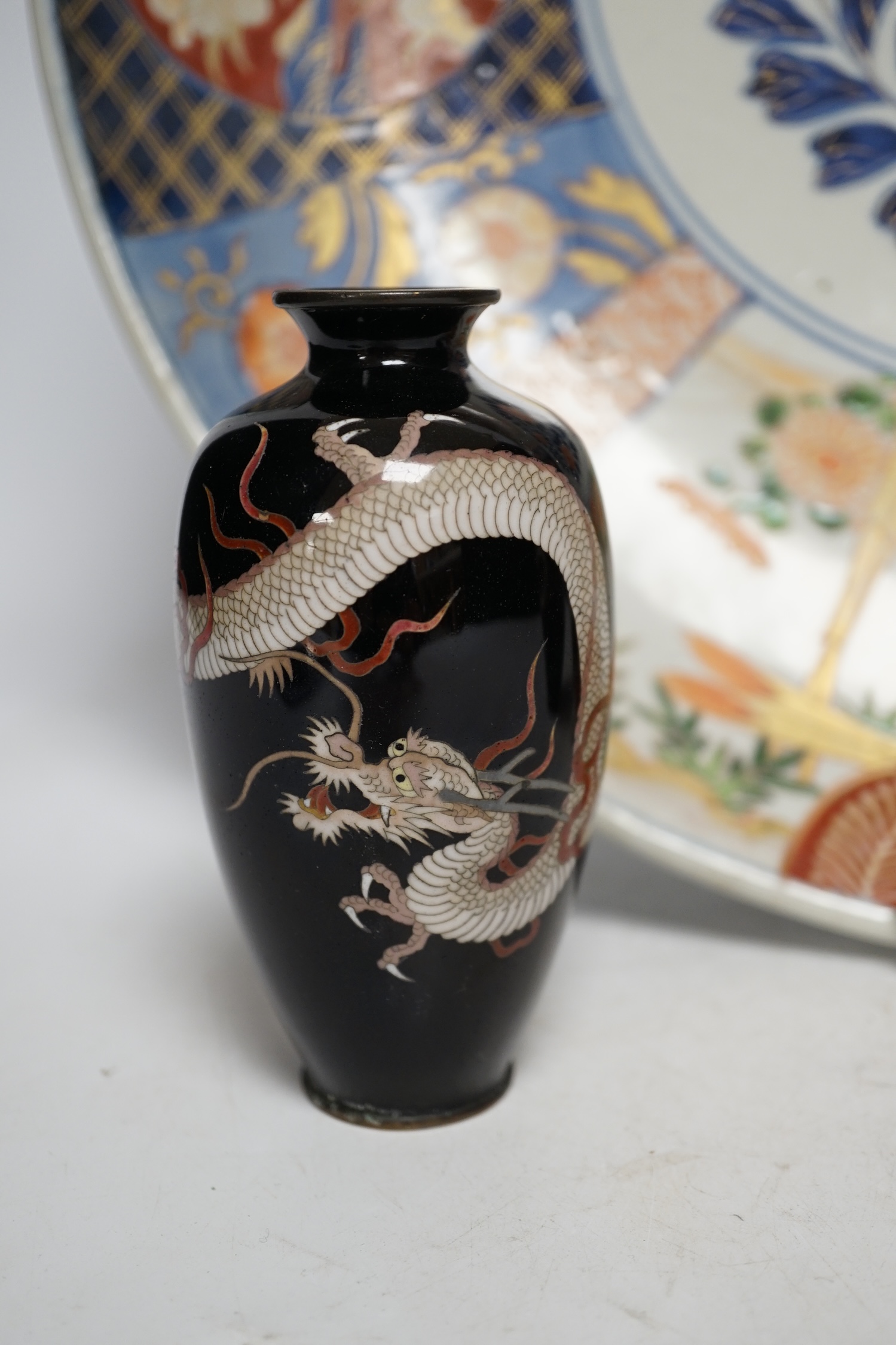 A pair of Japanese cloisonné enamel ‘dragon’ vases and a Japanese Imari dish, 39.5cm diameter (3). Condition - fair to good